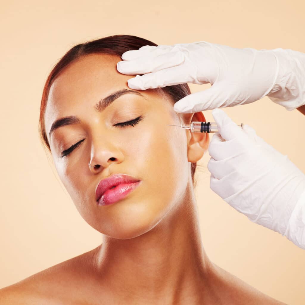 hands woman plastic surgery with needle facelift cosmetics isolated studio background cheek anti aging girl model with injection dermatology beauty glow medical procedure